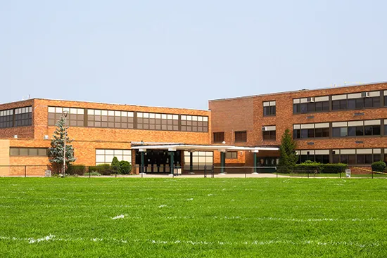 Exterior of a School with playing field visible in the foreground